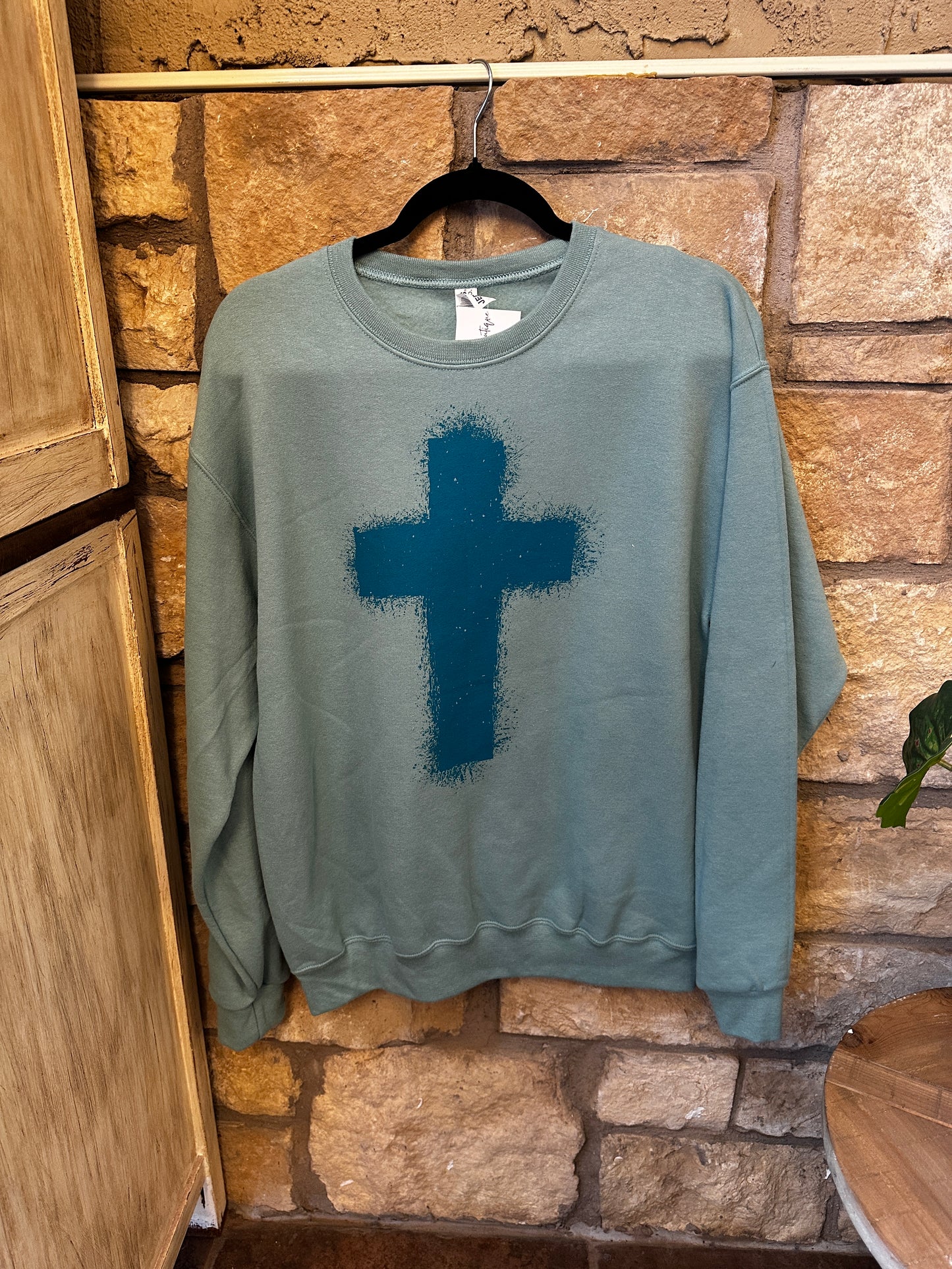 Turquoise cross sweatshirt
